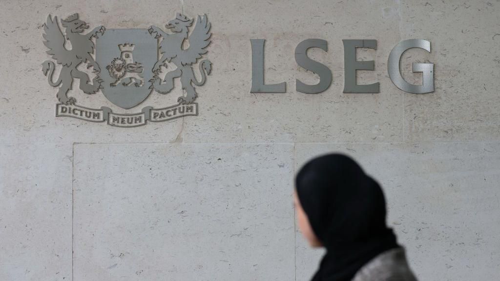 Woman in front of the London Stock Exchange building  