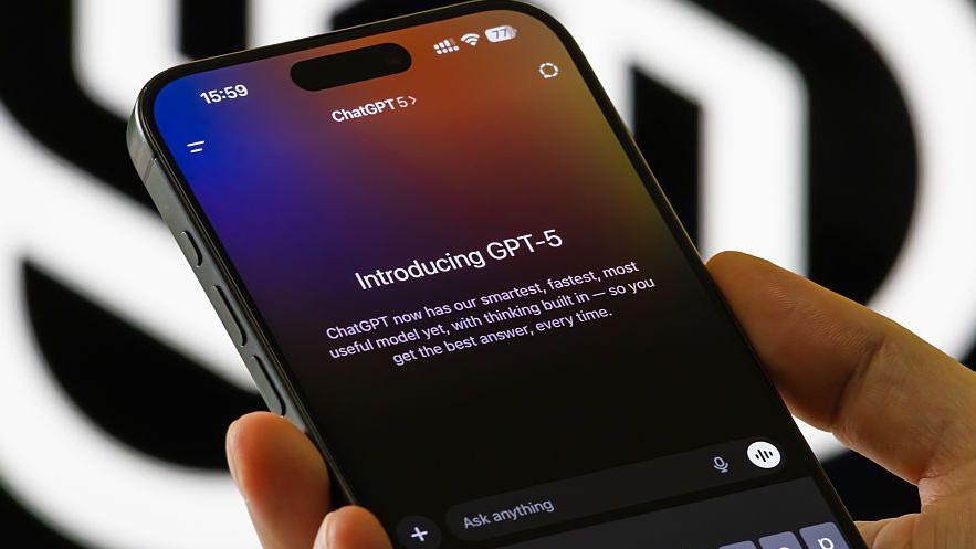 Close up of someone holding a smartphone showing the introduction to ChatGPT