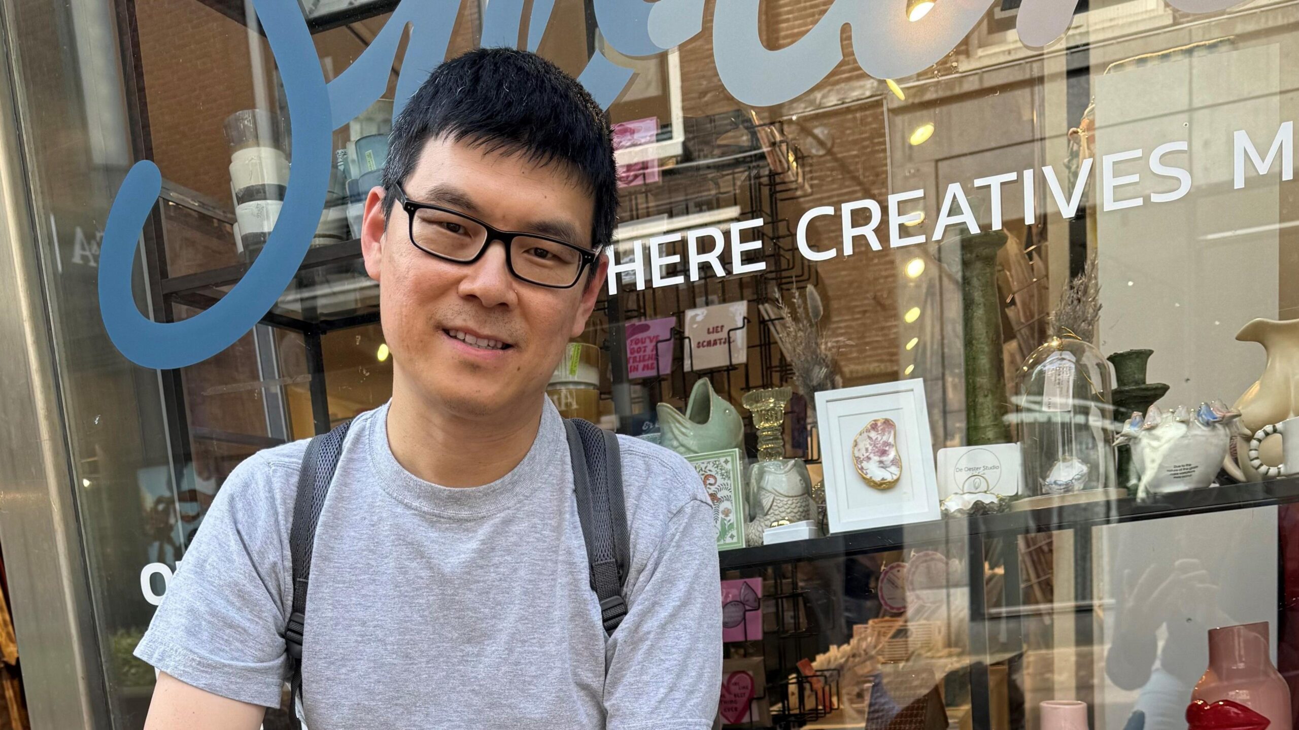 Shaolei Ren sitting outside a shop