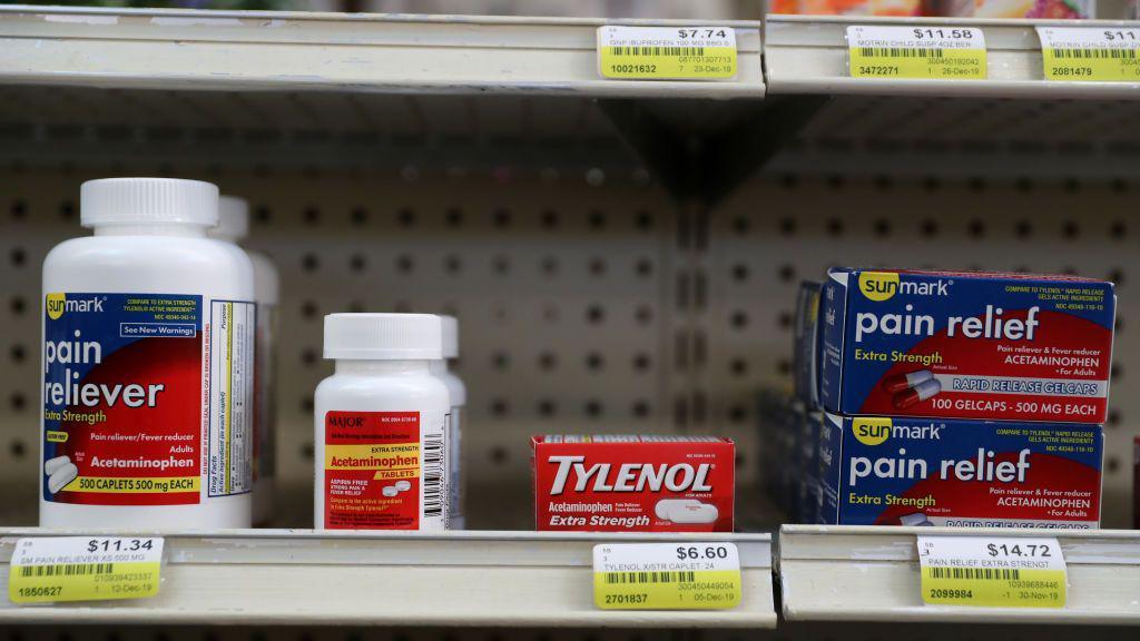 Tylenol and other pain relievers on a shelf in a drug store